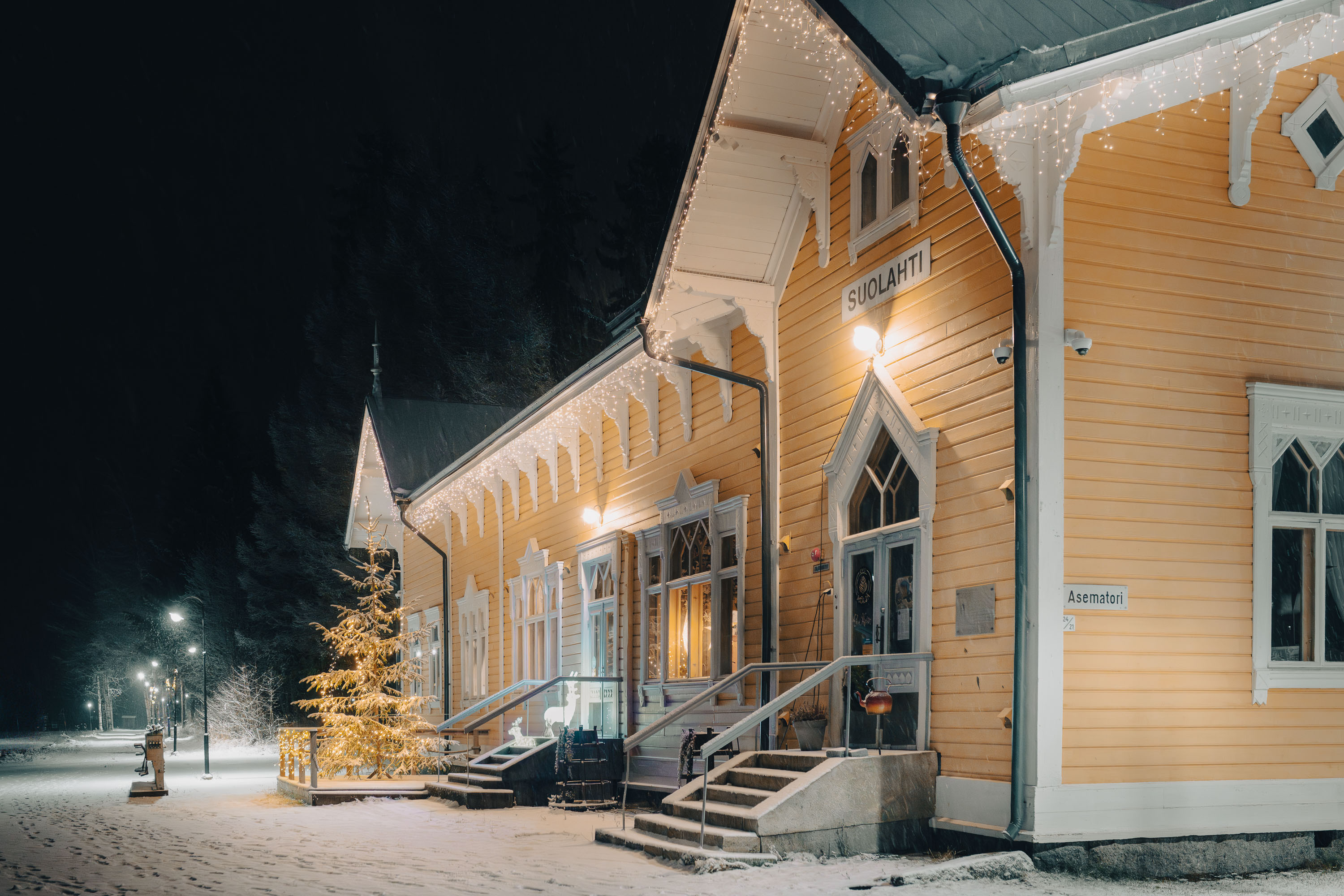 The Wanha Asema building at dusk, snowy scenery.